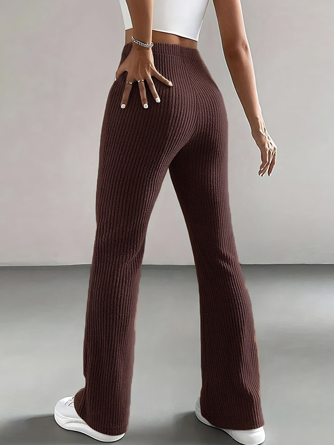 Brown ribbed pants worn by a person on a plain background