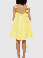 Yellow dress with floral straps on a white background