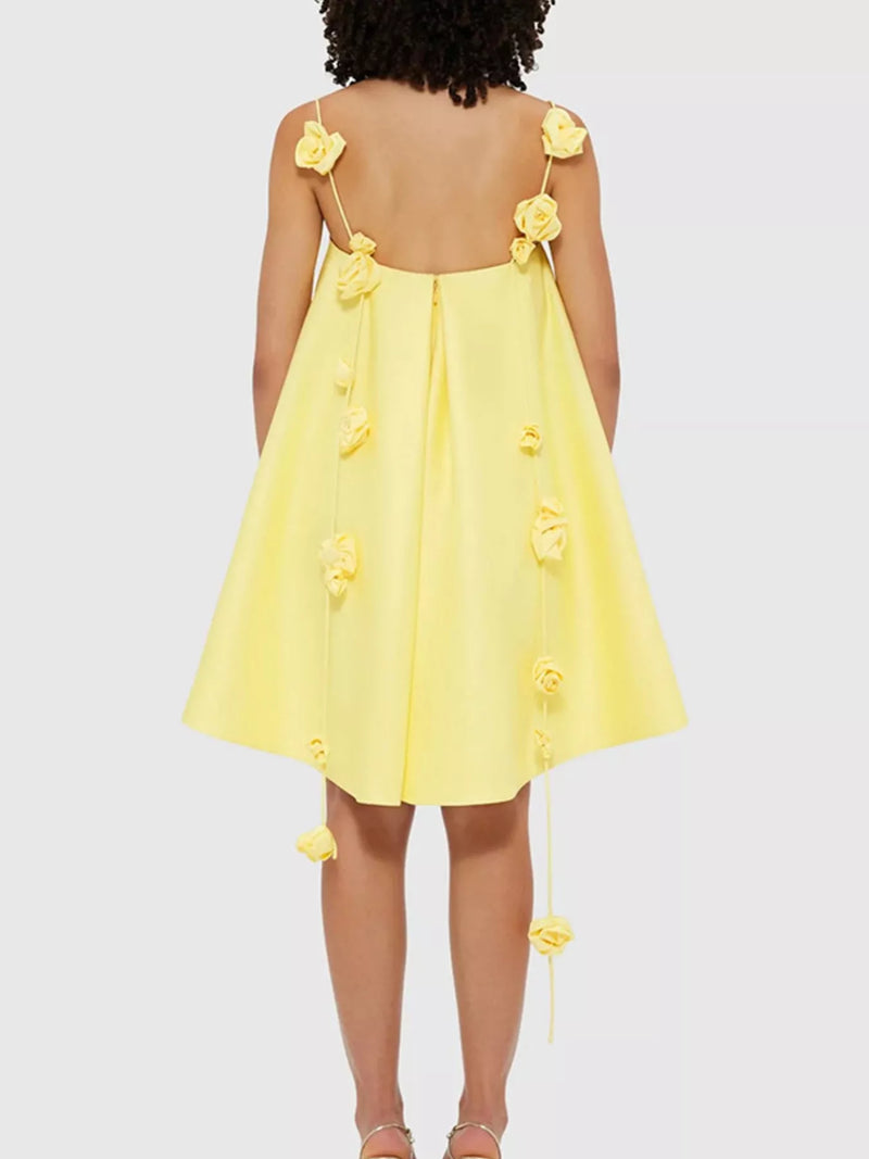Yellow dress with floral straps on a white background