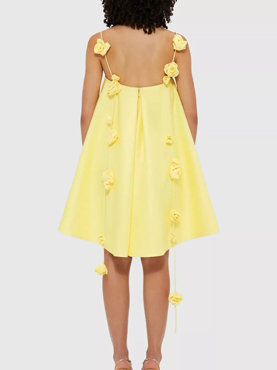 Yellow dress with floral straps on a white background