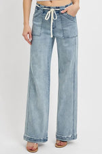 Light blue denim wide-leg pants with a drawstring waist on a white background