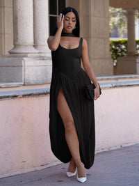 Woman in a black dress standing in front of classical architecture