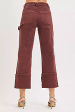 Brown pants with rolled-up cuffs on a white background