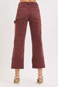 Brown pants with rolled-up cuffs on a white background
