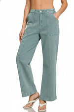 Teal pants worn by a person on a white background