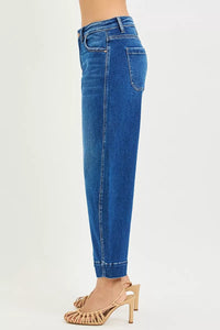 Blue jeans worn by a person on a white background