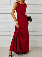 Woman wearing a red sleeveless dress against a light wooden panel background