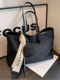 Black handbag with a visible brand tag on a surface