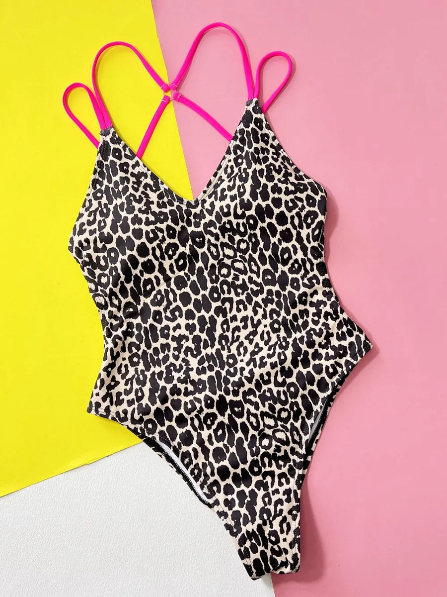 Leopard print swimsuit with pink straps on a colorful background