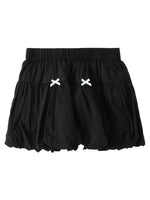 Black skirt with white bow details on a white background