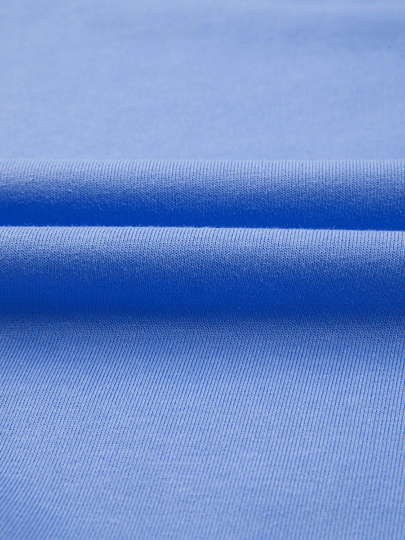 Close-up of blue fabric with a subtle pattern