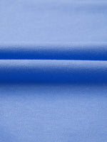 Close-up of blue fabric with a subtle pattern