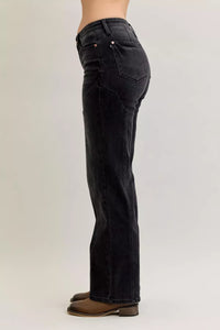 Black jeans worn by a person on a plain background
