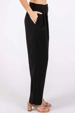 Black pants worn by a person on a white background