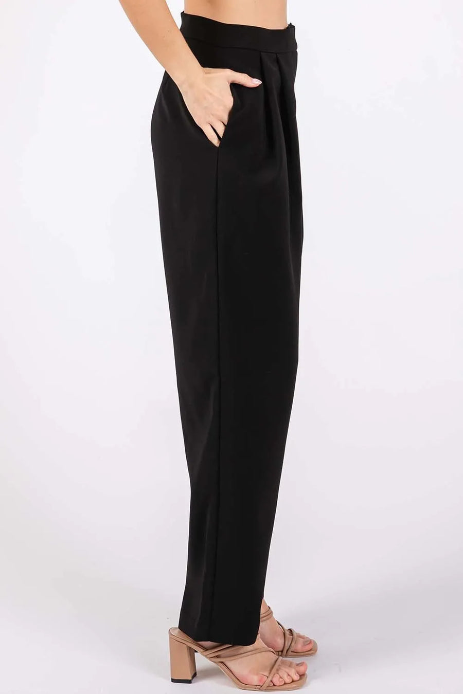 Black pants worn by a person on a white background