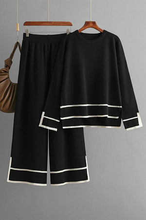 Black outfit with white trim on a gray background