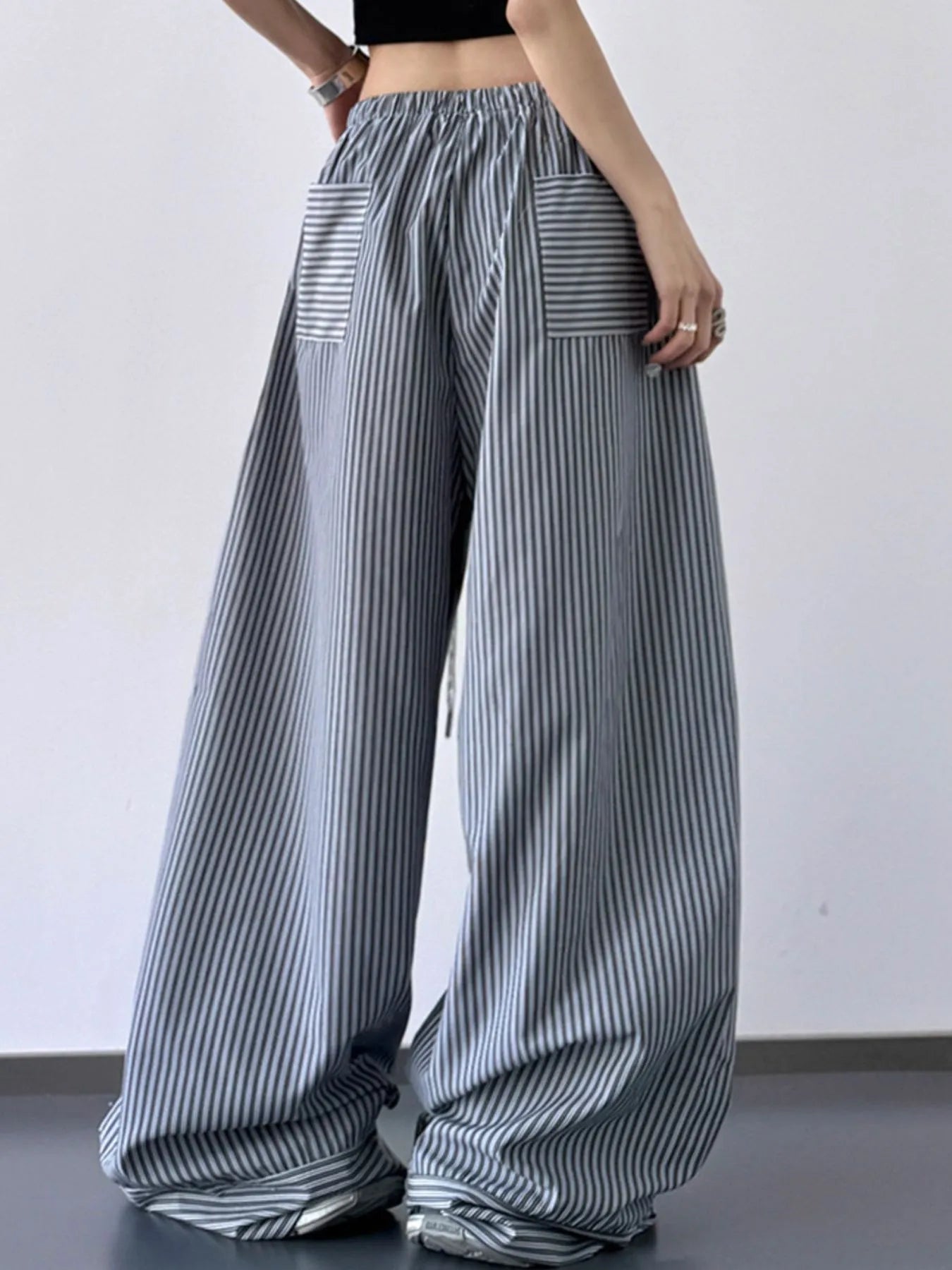 Striped wide-leg pants worn by a person on a plain background
