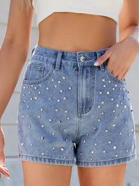 Denim shorts with rhinestone embellishments worn by a person.