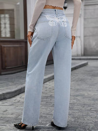 Light blue jeans worn by a person on a street.