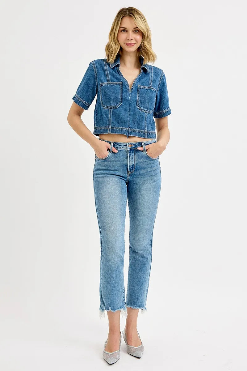 Woman wearing a denim jacket and jeans on a white background