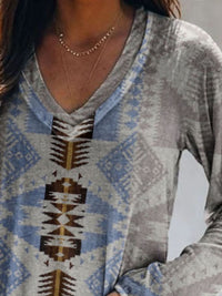 Person wearing a patterned long-sleeve shirt with a neutral background