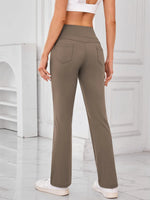 Person wearing olive green pants in a minimal indoor setting