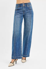 Blue jeans worn by a person on a white background