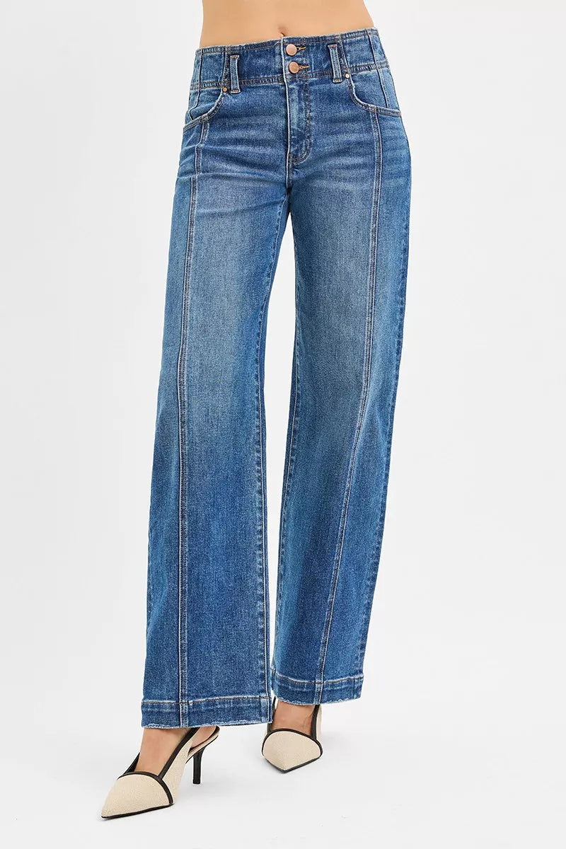 Blue jeans worn by a person on a white background