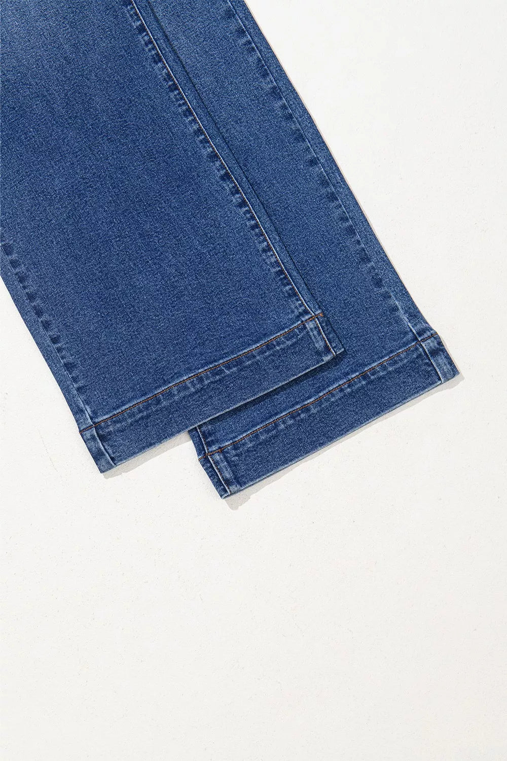 Close-up of blue jeans on a white background