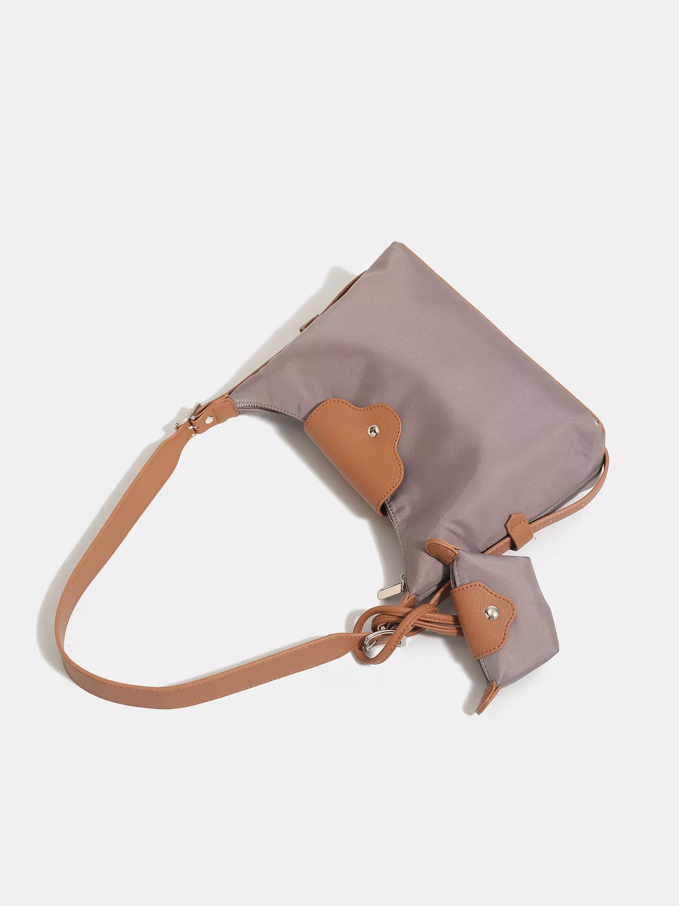 Gray and brown handbag with a strap on a white background