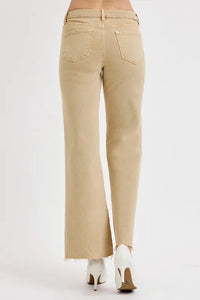 Beige pants worn by a person on a white background