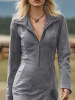 Woman wearing a gray zip-up jacket with a blurred natural background