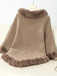 Brown poncho with fur trim on a white background