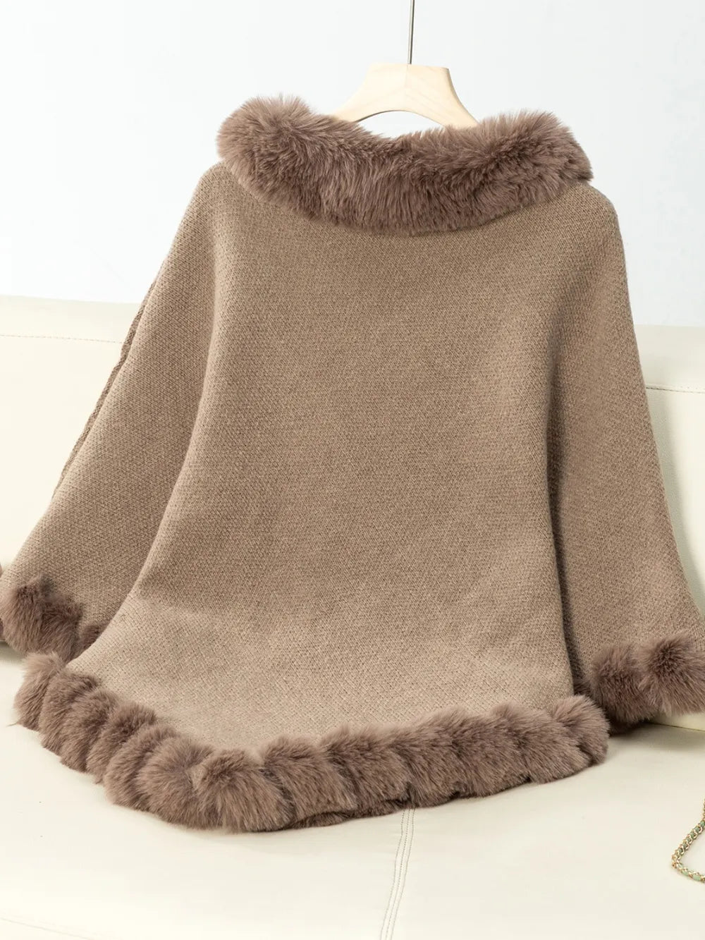 Brown poncho with fur trim on a white background