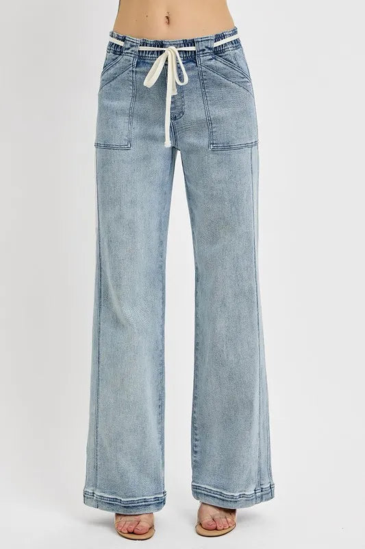 Light blue denim pants with a drawstring waist on a white background