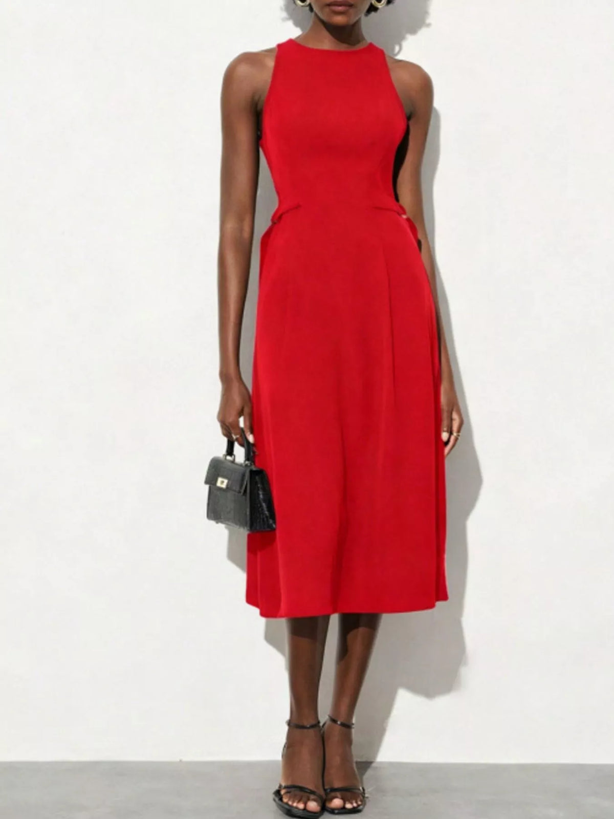 Red dress worn by a model on a white background
