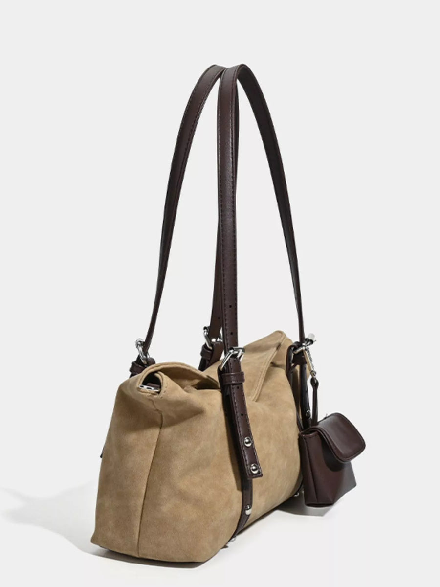 Brown leather backpack with a shoulder strap on a white background