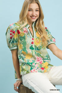 Woman wearing a floral blouse with a light blue background