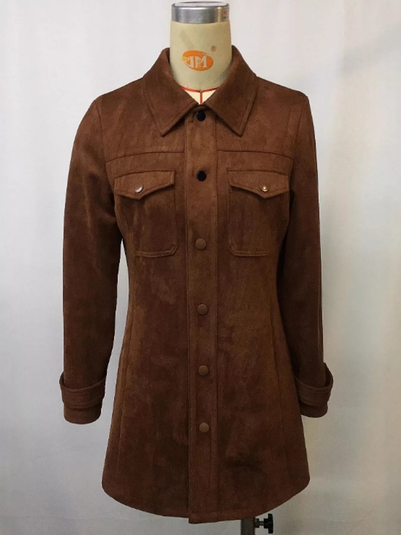 Brown suede jacket on a mannequin against a plain background