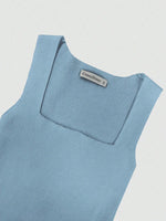 Light blue sleeveless top with a brand label on a light gray background