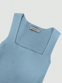 Light blue sleeveless top with a brand label on a light gray background