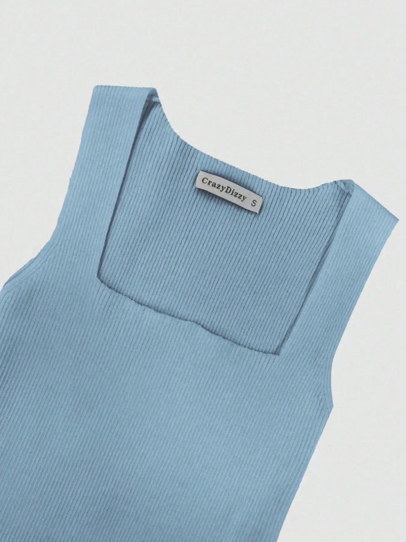 Light blue sleeveless top with a brand label on a light gray background
