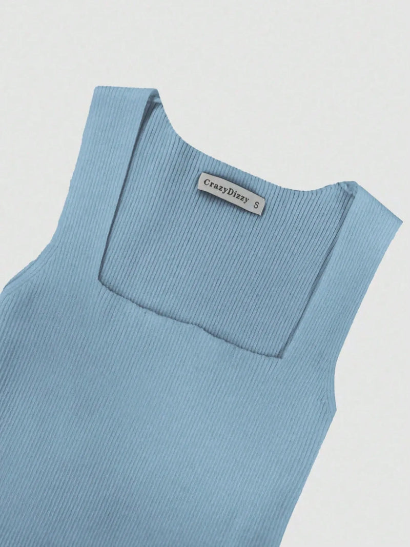 Light blue sleeveless top with a brand label on a light gray background