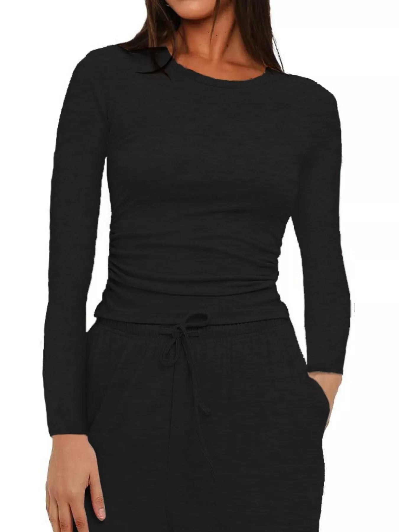 Black long-sleeve top worn by a person on a white background