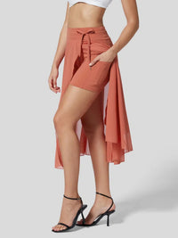 Person wearing a peach-colored wrap skirt on a plain background