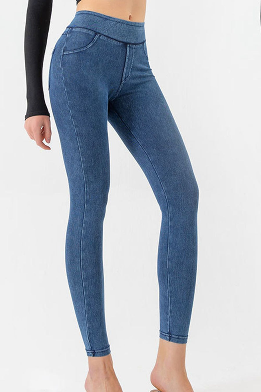 Blue jeans worn by a person on a white background