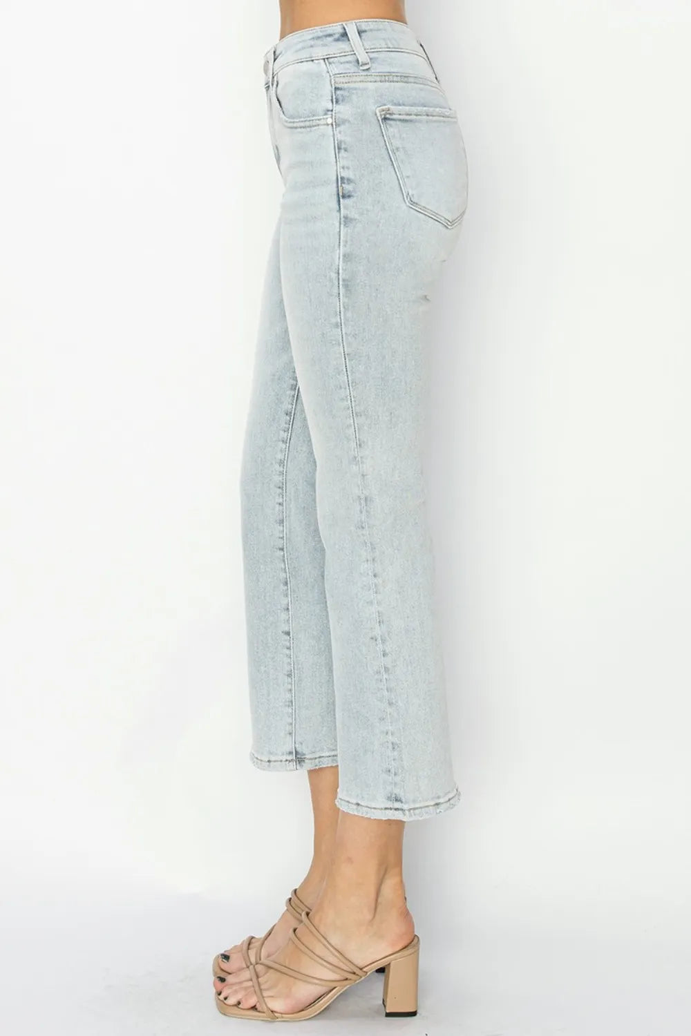 Light blue jeans worn by a person on a white background