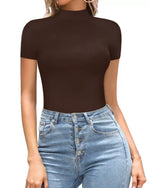 Person wearing a brown short-sleeve top and blue jeans on a white background