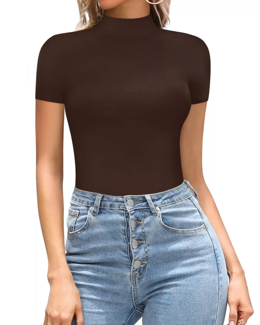 Person wearing a brown short-sleeve top and blue jeans on a white background