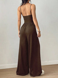 Brown jumpsuit worn by a person against a plain background